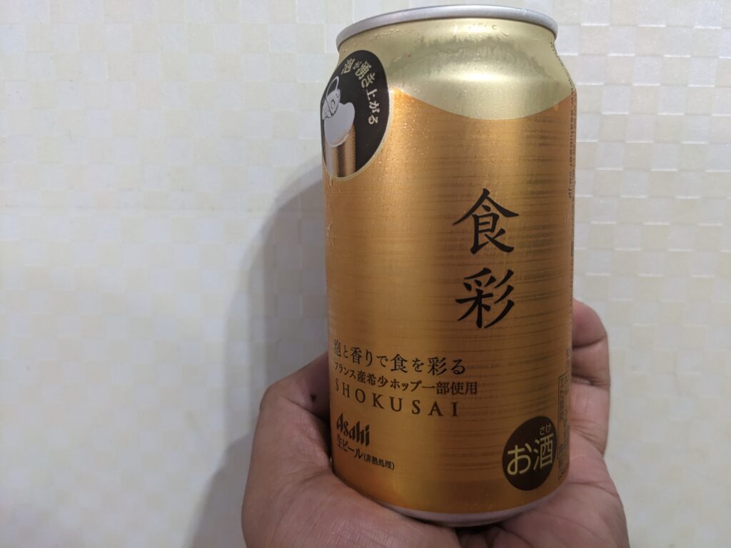 「アサヒ食彩」を手で持っている