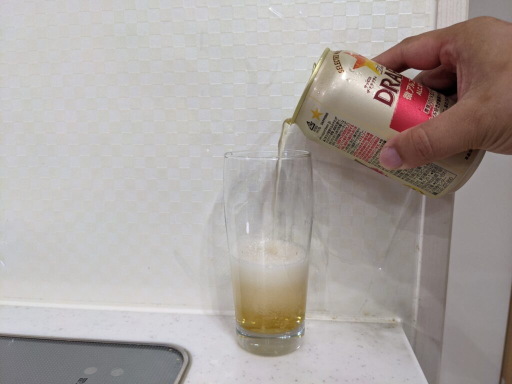 サッポロザ・ドラフティをコップに注いで泡が出ている