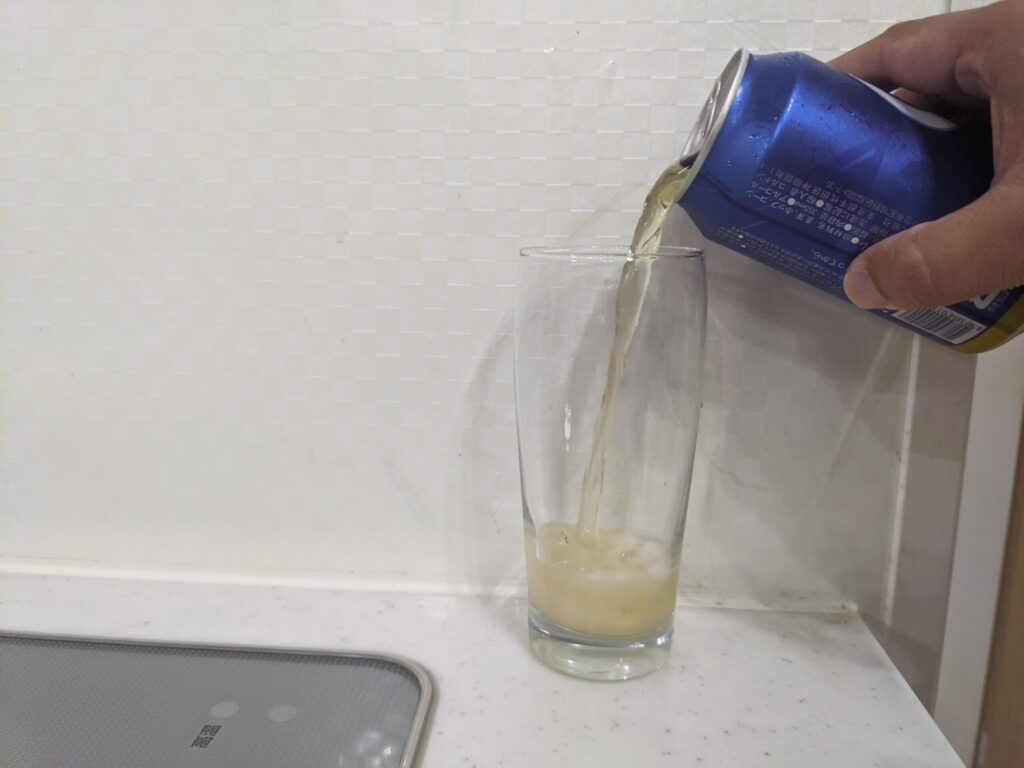 グラスにcass（カス）フレッシュビールを注いでいる
