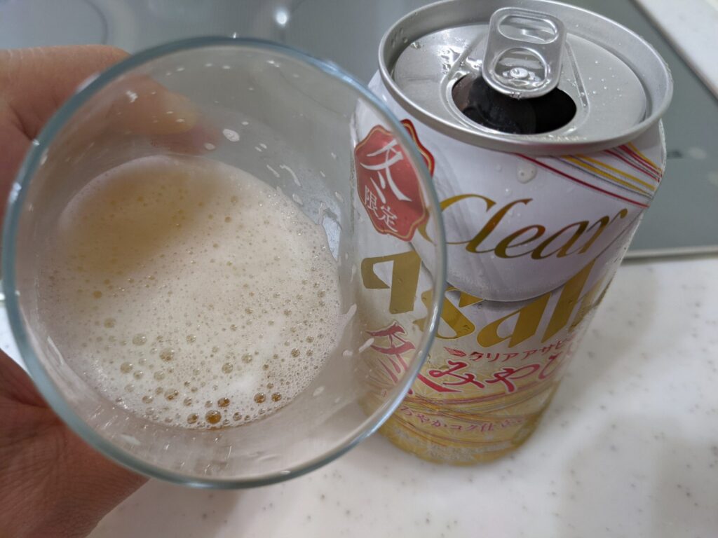 「クリアアサヒ冬みやび」が入ったグラスを傾けているところ